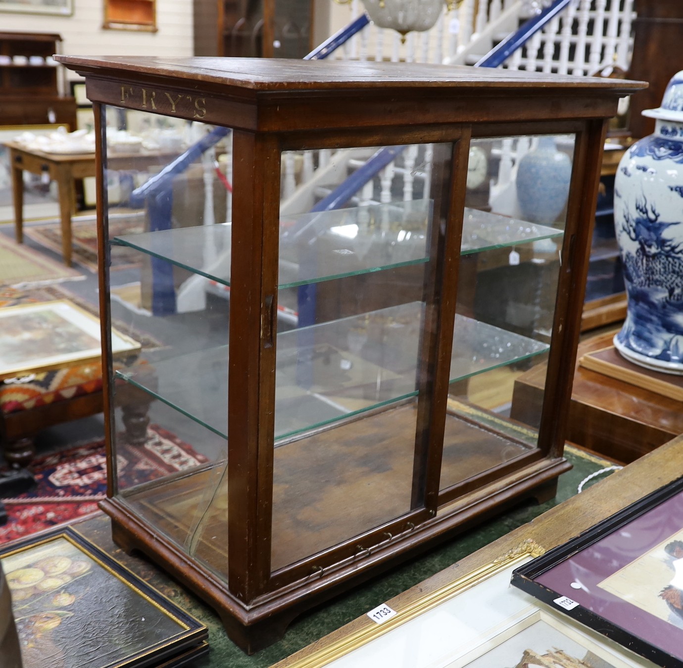 A late Victorian / Edwardian mahogany Fry’s Chocolates counter shop display cabinet with gilded lettering, width 81cms, depth 47cms, height 77cms.